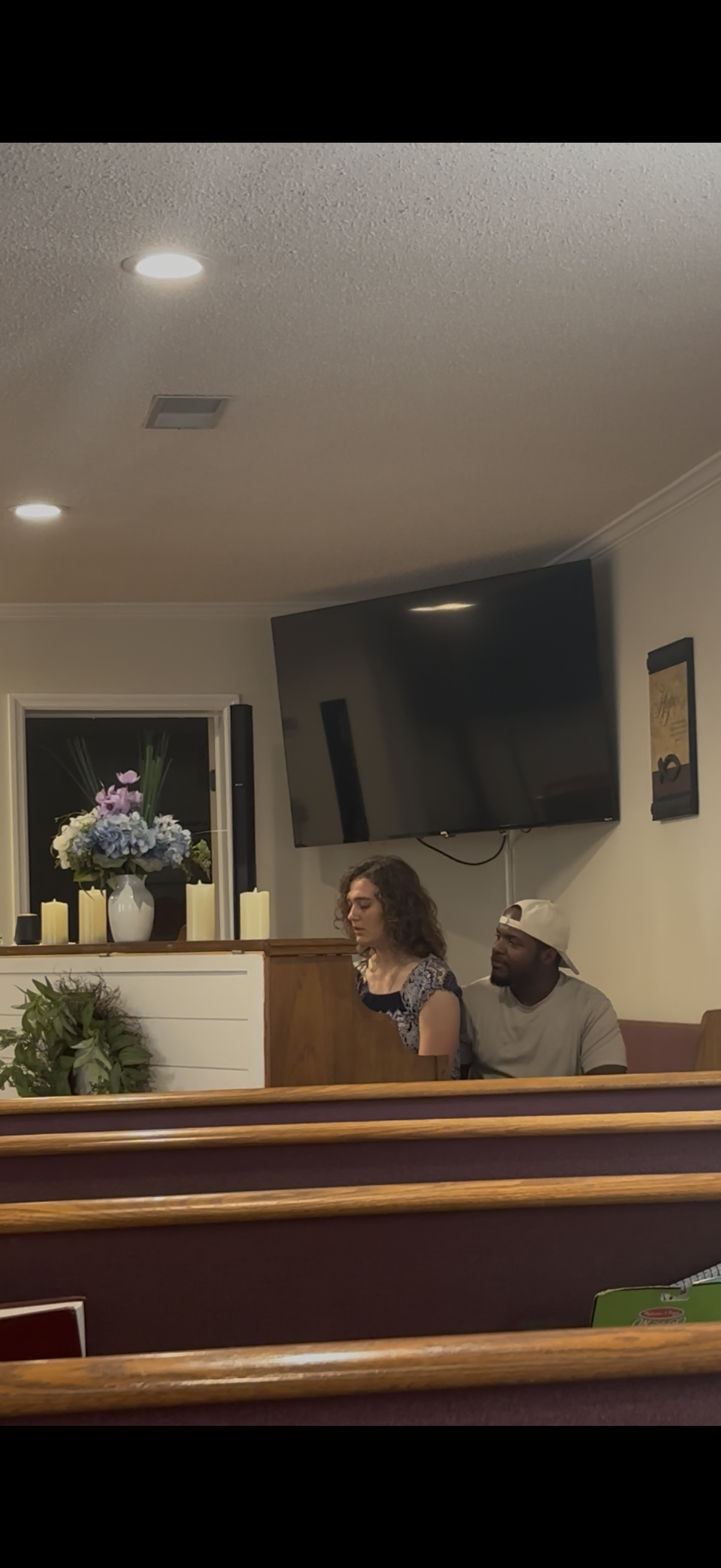 Two people sharing a meaningful moment at Rhodesville Freewill Baptist Church